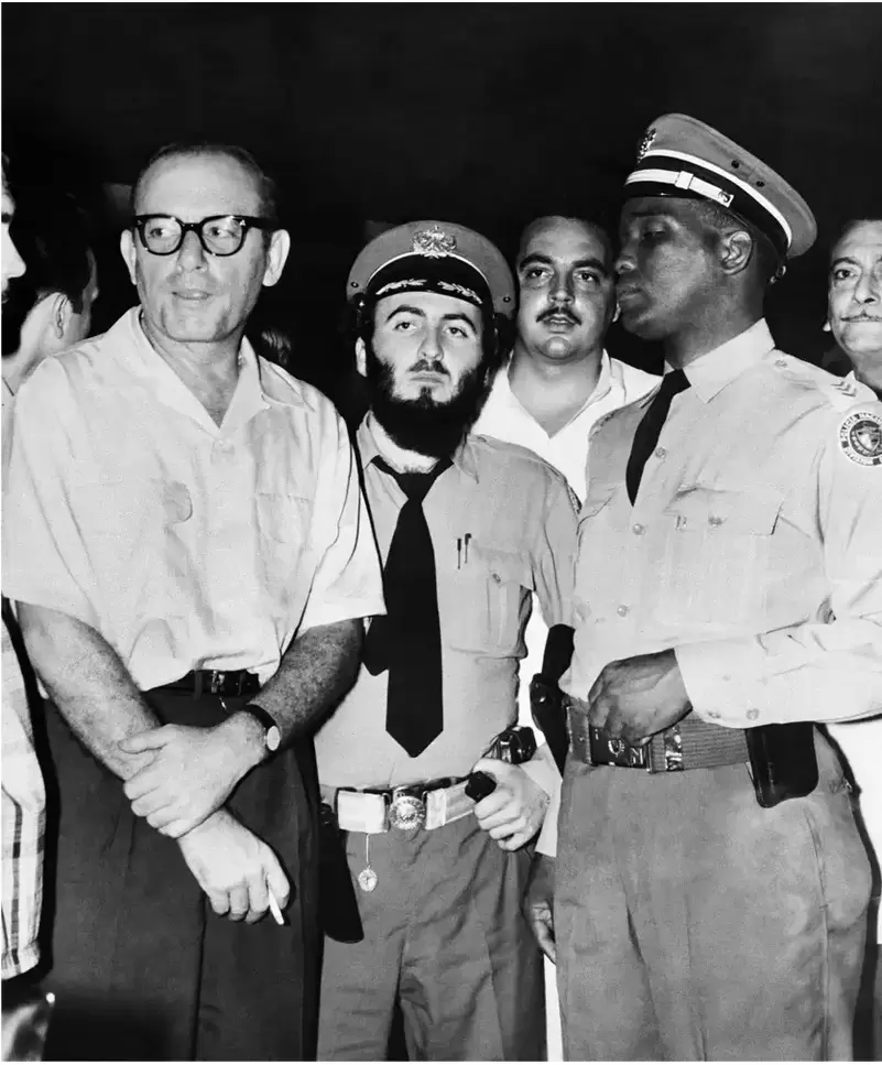Santo Trafficante Jr, above, left, was detained after Fidel castro came to power in 1959. He is with Cuban police days before his arrest.