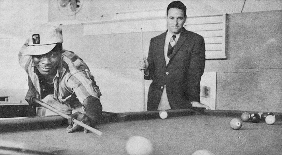Dick Greco (right) plays pool with a potential voter.